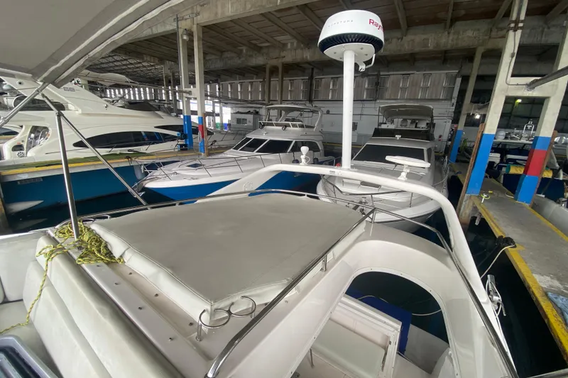 Slide: The Image of 2006 Regal Commodore 3880 yacht docked in a covered marina. - 19