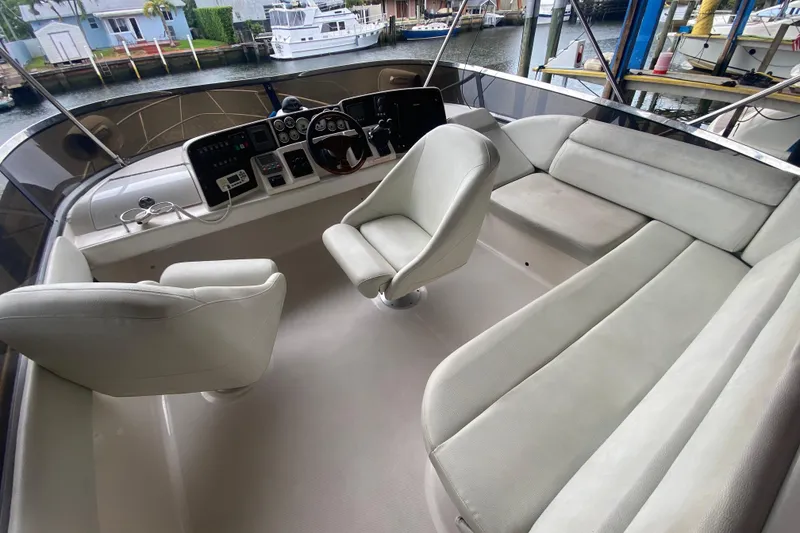 Slide: The Image of 2006 Regal Commodore 3880 yacht cockpit with white seating and control panel. - 20