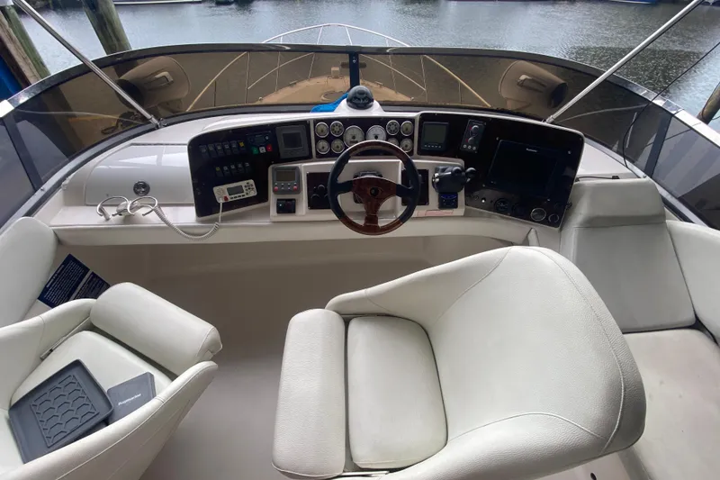 Slide: The Image of Cockpit of 2006 Regal Commodore 3880 yacht with steering wheel and control panels. - 22
