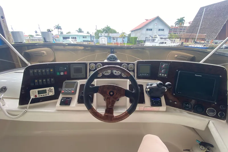 Slide: The Image of Helm of 2006 Regal Commodore 3880 yacht with navigation controls and steering wheel. - 23
