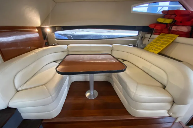 Slide: The Image of Luxurious interior of 2006 Regal Commodore 3880 yacht with plush seating and wooden table. - 29
