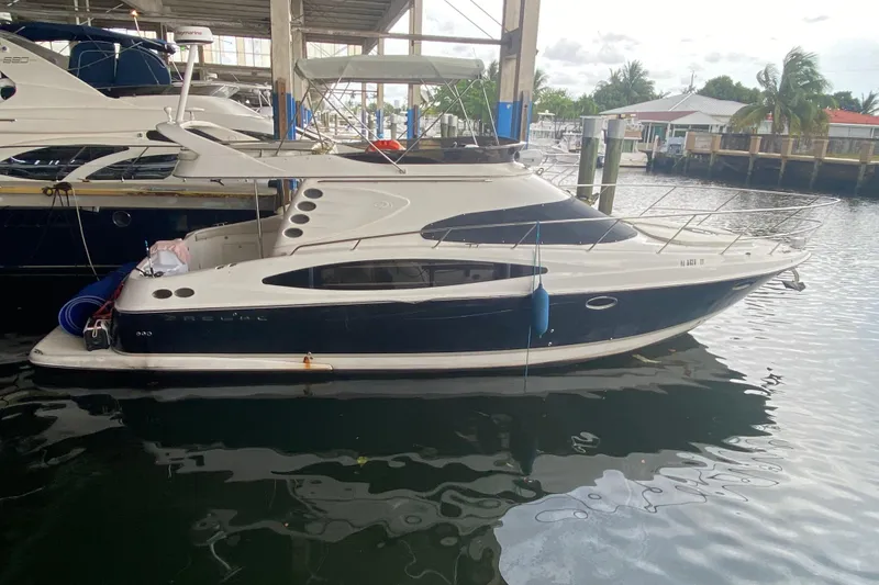 Slide: The Image of 2006 Regal Commodore 3880 yacht docked in a marina, featuring sleek design and modern amenities. - 3