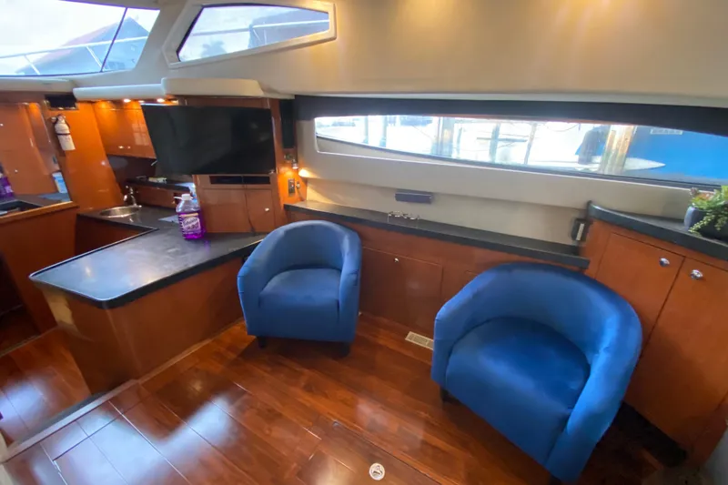 Slide: The Image of Luxurious interior of 2006 Regal Commodore 3880 yacht with blue chairs and modern amenities. - 30
