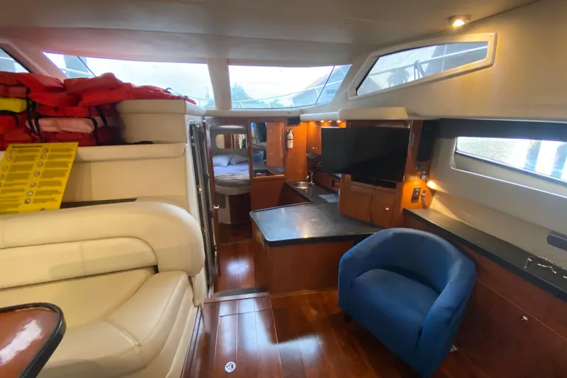 Slide: The Image of Luxurious interior of 2006 Regal Commodore 3880 yacht with seating, TV, and wood finishes. - 32
