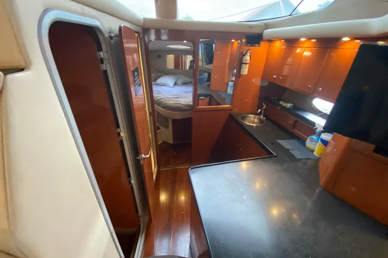 Slide: The Image of Interior of 2006 Regal Commodore 3880 yacht with kitchen and cozy bedroom. - 33
