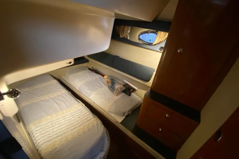 Slide: The Image of Cozy cabin interior of 2006 Regal Commodore 3880 yacht with twin beds and wooden cabinetry. - 34