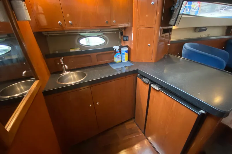 Slide: The Image of Luxurious 2006 Regal Commodore 3880 yacht kitchen with wood cabinetry and modern appliances. - 36