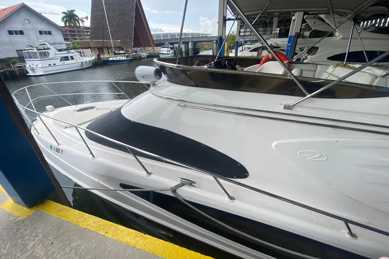 Slide: The Image of 2006 Regal Commodore 3880 yacht docked in a marina, showcasing sleek design and luxury features. - 4