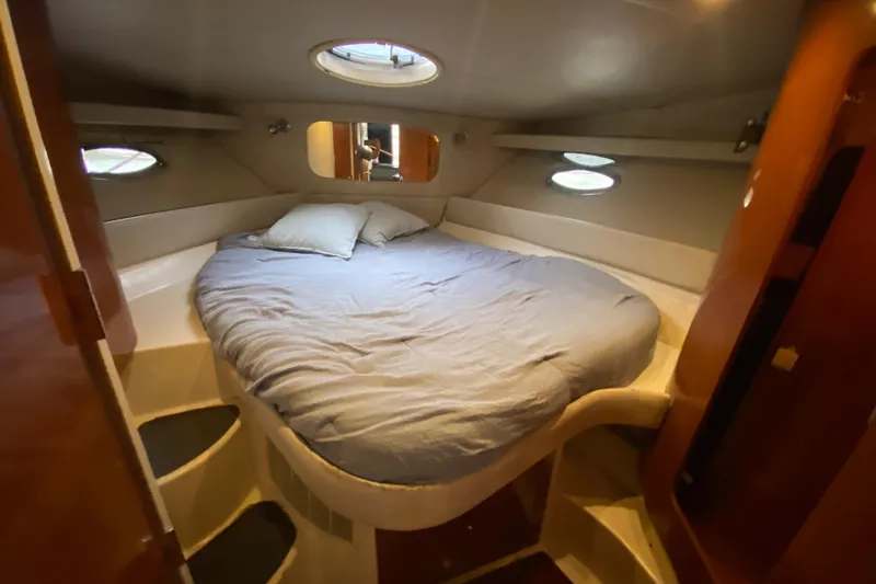 Slide: The Image of Cozy cabin interior of 2006 Regal Commodore 3880 yacht with circular bed and portholes. - 42