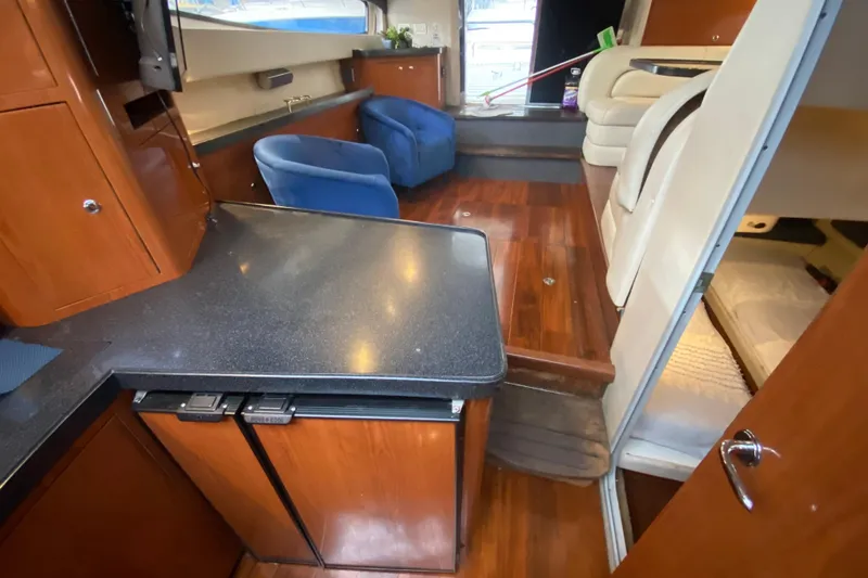 Slide: The Image of Interior of 2006 Regal Commodore 3880 yacht with wood flooring and modern furnishings. - 45