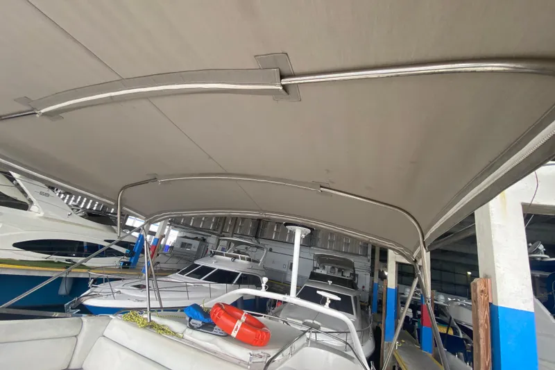 Slide: The Image of 2006 Regal Commodore 3880 yacht with canopy in marina storage. - 49