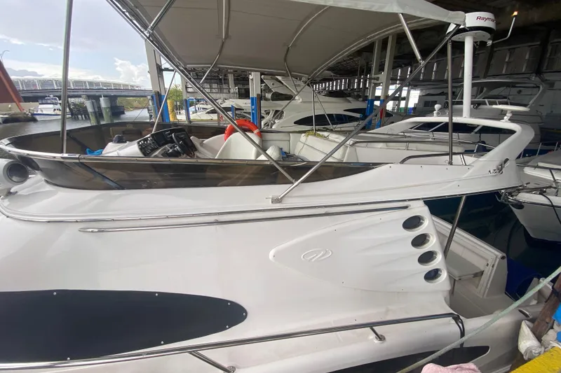 Slide: The Image of 2006 Regal Commodore 3880 yacht docked in a marina under a canopy. - 5