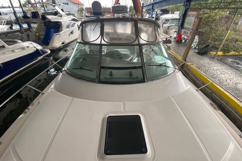 Slide: The Image of 2000 Sea Ray 460 Express Cruiser docked in marina, front view. - 10