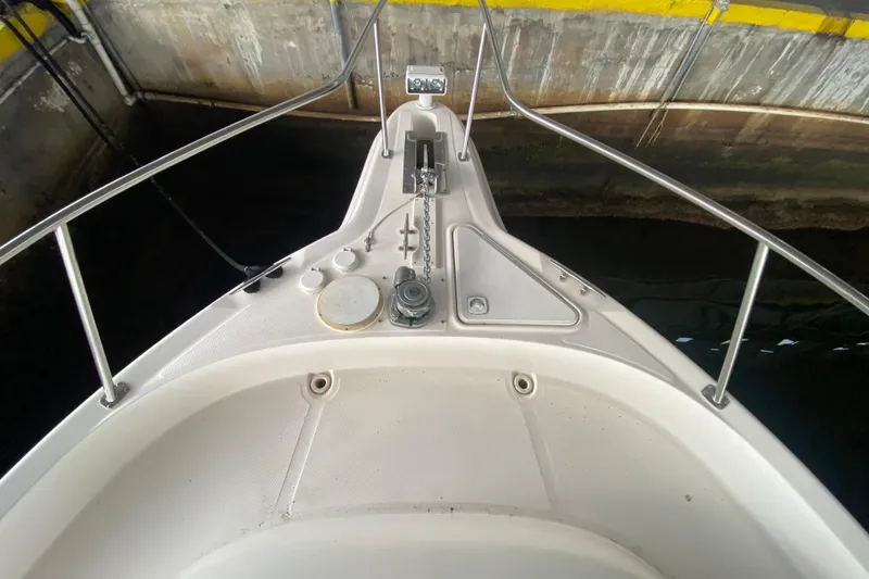 Slide: The Image of Bow of 2000 Sea Ray 460 Express Cruiser in dock, featuring anchor and railings. - 11