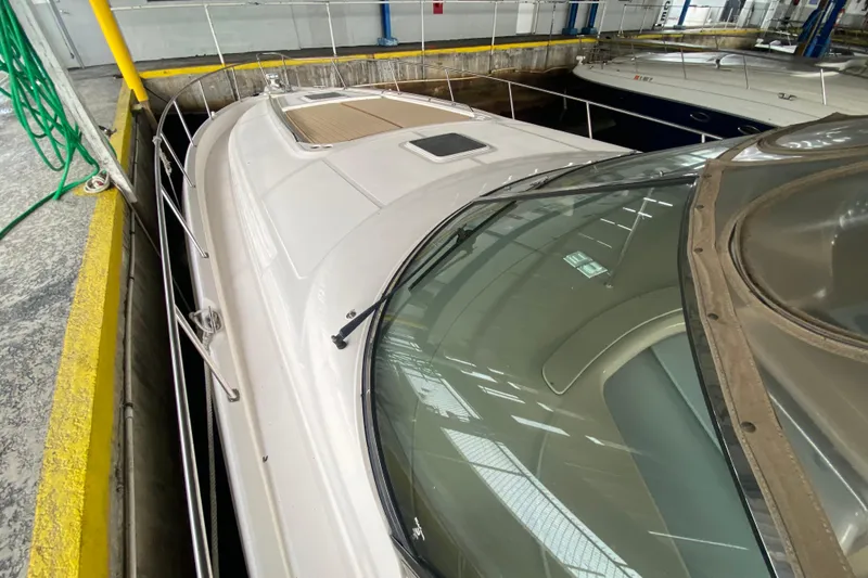 Slide: The Image of 2000 Sea Ray 460 Express Cruiser docked in a marina, showcasing sleek design and spacious deck. - 14