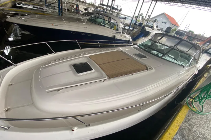 Slide: The Image of 2000 Sea Ray 460 Express Cruiser docked in a marina, showcasing sleek design and spacious deck. - 2