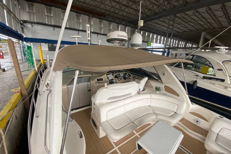 Slide: The Image of 2000 Sea Ray 460 Express Cruiser with spacious cockpit and canopy in marina setting. - 20