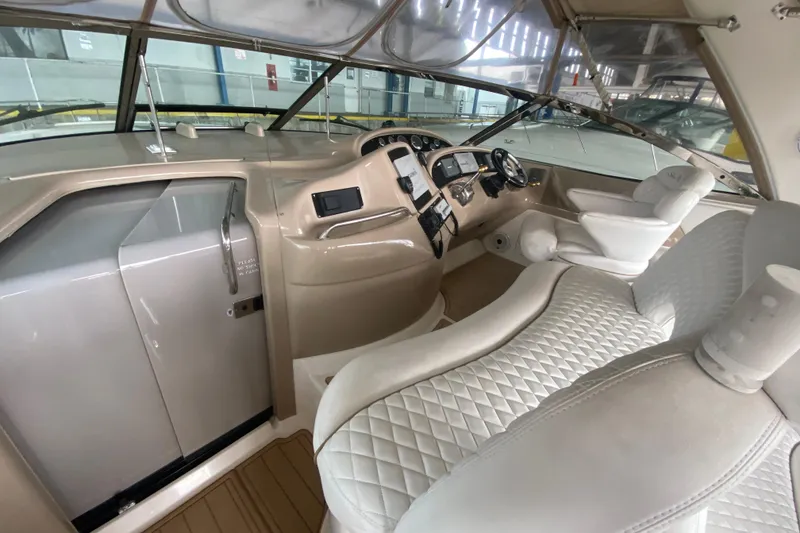 Slide: The Image of Interior of a 2000 Sea Ray 460 Express Cruiser with luxurious seating and modern dashboard. - 21