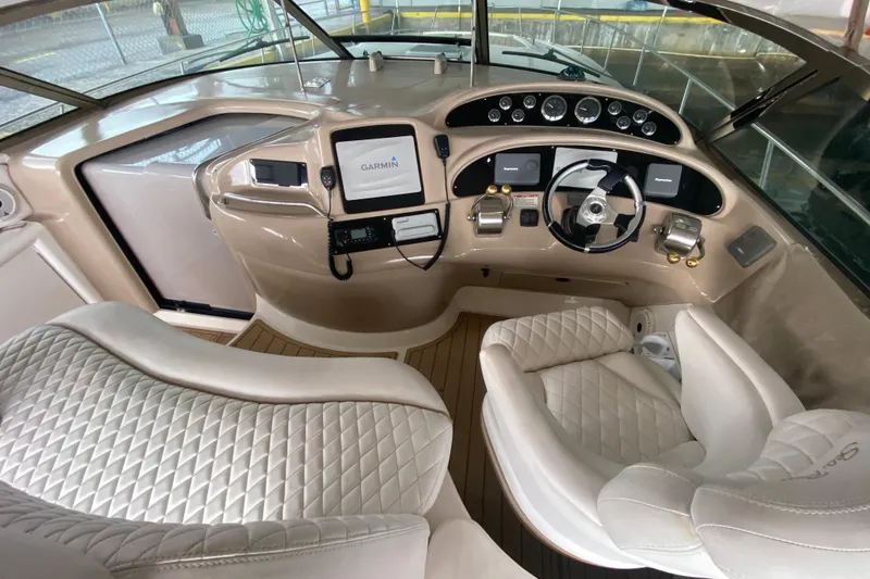 Slide: The Image of Luxurious helm of 2000 Sea Ray 460 Express Cruiser with modern navigation equipment. - 23