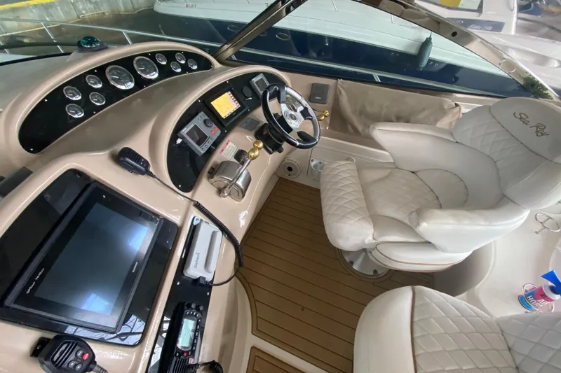 Slide: The Image of Cockpit of 2000 Sea Ray 460 Express Cruiser with modern navigation equipment and plush seating. - 25