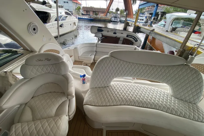 Slide: The Image of Luxurious interior of a 2000 Sea Ray 460 Express Cruiser with plush white seating. - 26