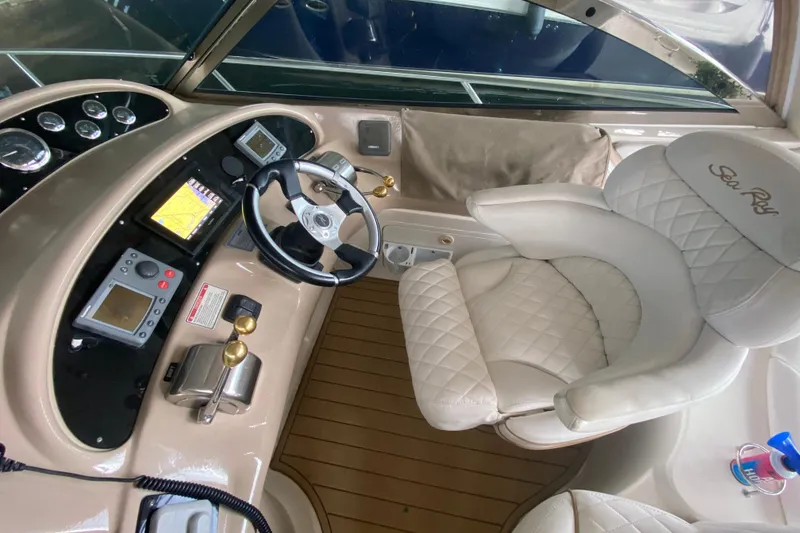 Slide: The Image of Cockpit of 2000 Sea Ray 460 Express Cruiser with steering wheel and navigation controls. - 27