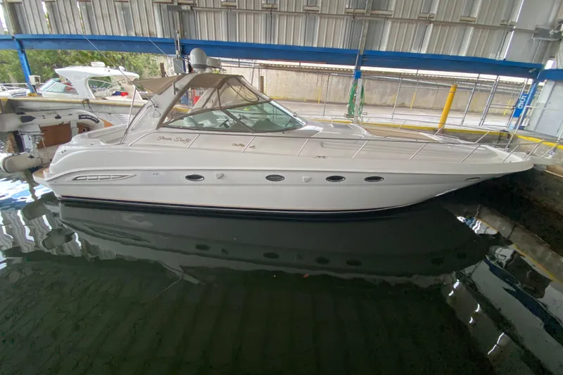 Slide: The Image of 2000 Sea Ray 460 Express Cruiser docked in a covered marina. - 28