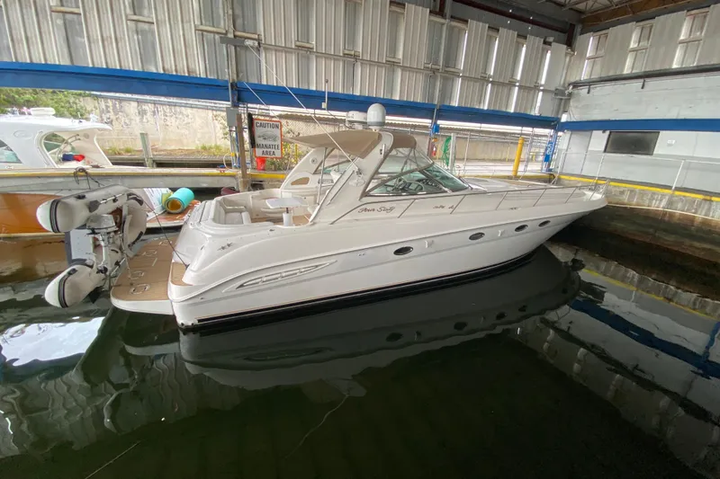 Slide: The Image of 2000 Sea Ray 460 Express Cruiser docked in a covered marina. - 29