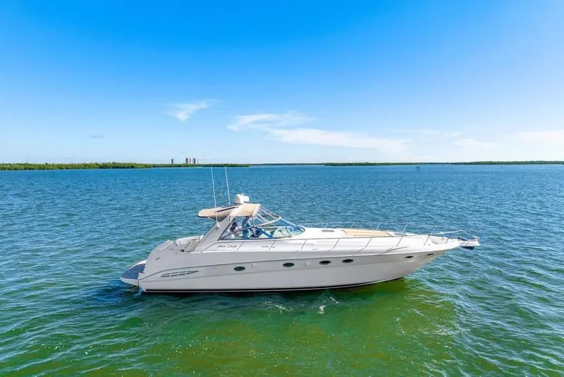 Slide: The Image of 2000 Sea Ray 460 Express Cruiser on open water under clear blue sky. - 32