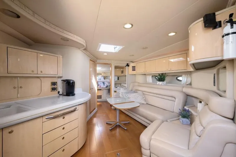 Slide: The Image of Luxurious interior of 2000 Sea Ray 460 Express Cruiser with modern kitchen and seating area. - 34