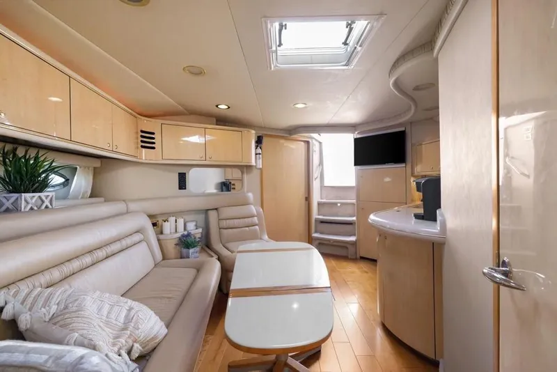 Slide: The Image of Luxurious interior of 2000 Sea Ray 460 Express Cruiser with modern furnishings and natural light. - 35