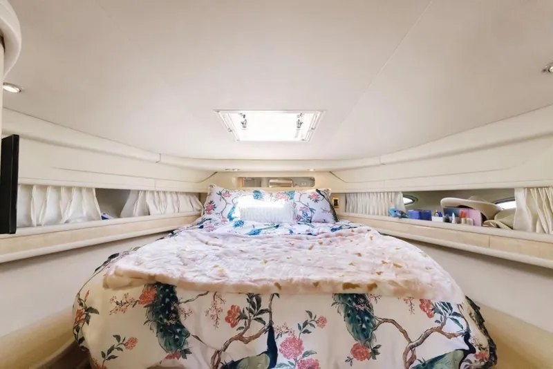 Slide: The Image of Luxurious cabin interior of 2000 Sea Ray 460 Express Cruiser with floral bedding. - 38