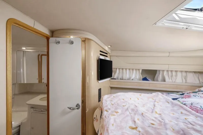 Slide: The Image of Interior of 2000 Sea Ray 460 Express Cruiser with cozy bedroom and bathroom. - 39