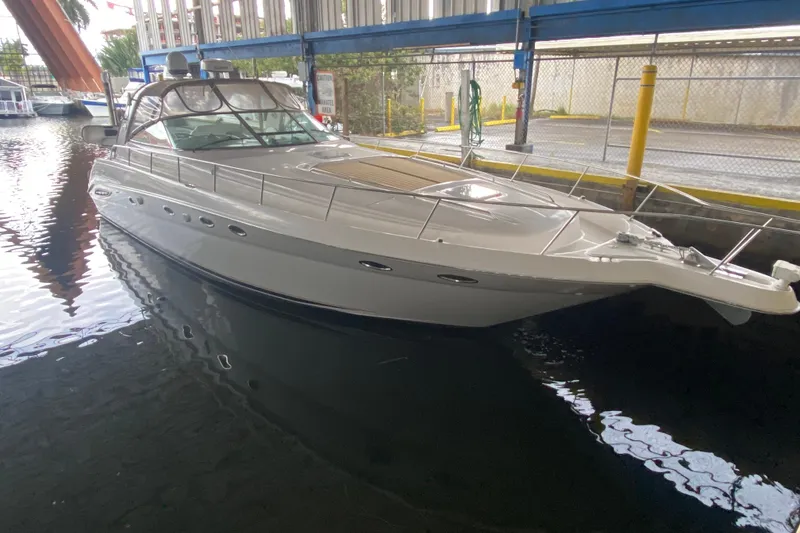 Slide: The Image of 2000 Sea Ray 460 Express Cruiser docked in a marina under a bridge. - 4