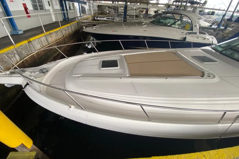 Slide: The Image of 2000 Sea Ray 460 Express Cruiser docked in a marina, showcasing sleek design and spacious deck. - 5