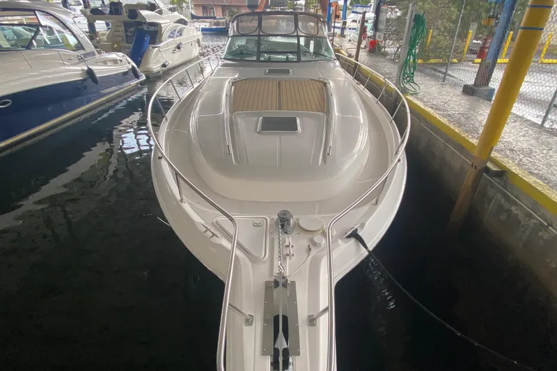 Slide: The Image of 2000 Sea Ray 460 Express Cruiser docked in marina, top view of sleek design. - 6