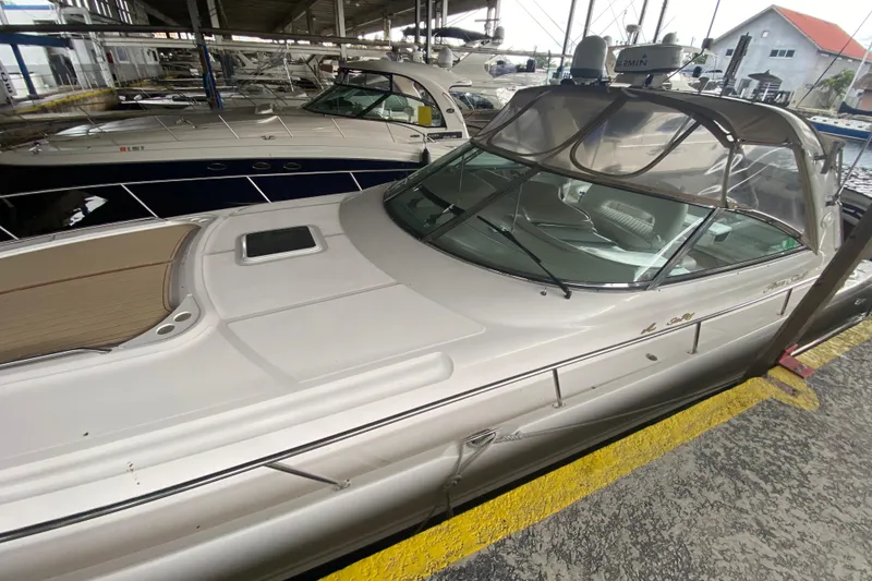 Slide: The Image of 2000 Sea Ray 460 Express Cruiser docked in a marina, showcasing sleek design and spacious deck. - 7