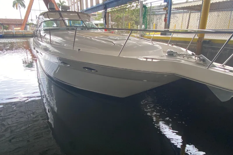 Slide: The Image of 2000 Sea Ray 460 Express Cruiser docked in a marina, side view. - 8