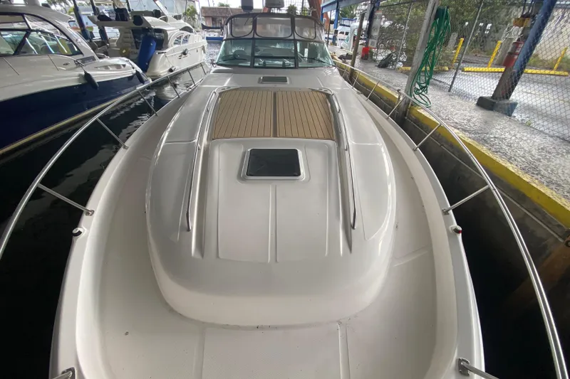 Slide: The Image of 2000 Sea Ray 460 Express Cruiser docked, showcasing sleek design and spacious deck. - 9