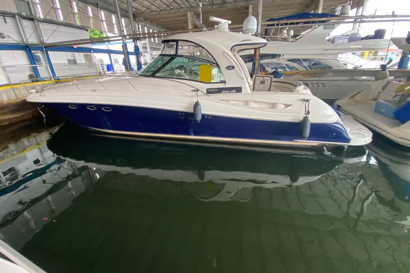 The Image of 2005 Sea Ray 500 Sundancer yacht docked in a marina, featuring a sleek blue and white design. - 0