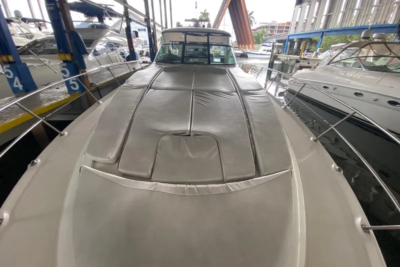 Slide: The Image of 2005 Sea Ray 500 Sundancer yacht docked in marina, showcasing sleek design and spacious deck. - 12