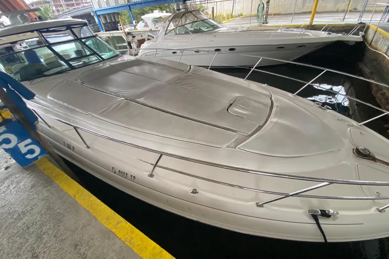 Slide: The Image of 2005 Sea Ray 500 Sundancer yacht docked in marina, covered deck, sleek design. - 2