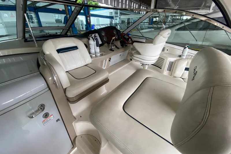 Slide: The Image of Interior of 2005 Sea Ray 500 Sundancer yacht with white leather seating and helm. - 21