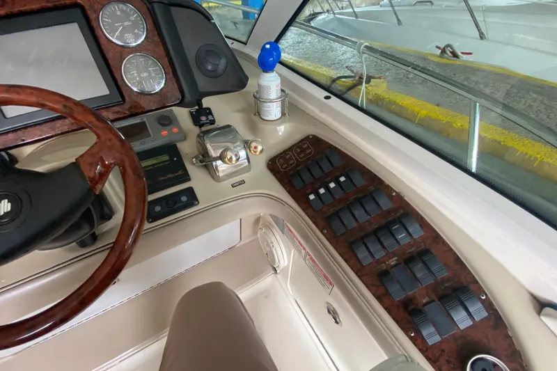 Slide: The Image of Helm of 2005 Sea Ray 500 Sundancer with wood accents and control panels. - 23