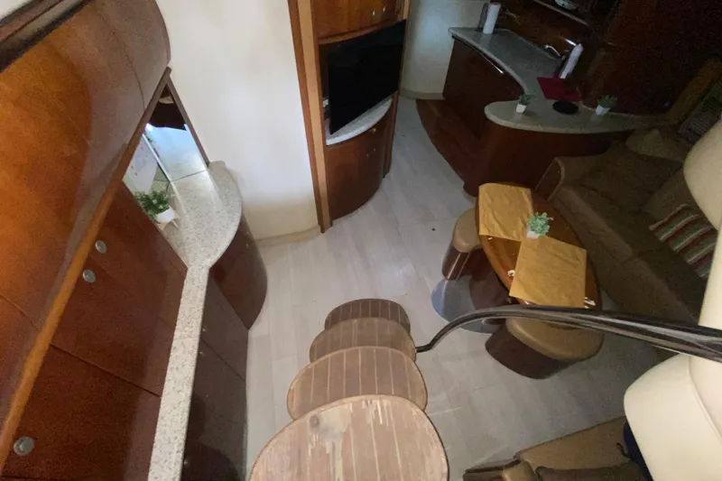 Slide: The Image of Interior of 2005 Sea Ray 500 Sundancer yacht with elegant wood finishes and modern amenities. - 26