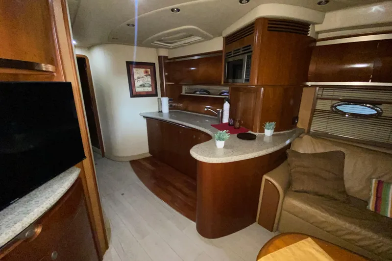 Slide: The Image of Luxurious interior of a 2005 Sea Ray 500 Sundancer yacht with modern kitchen amenities. - 28