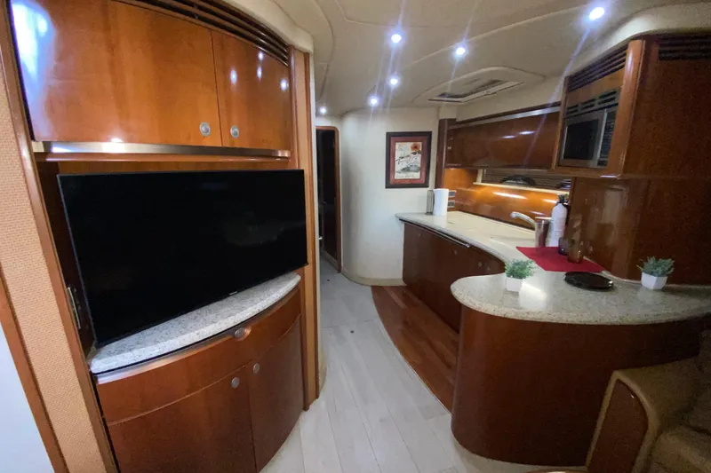 Slide: The Image of Luxurious interior of 2005 Sea Ray 500 Sundancer yacht with modern kitchen and entertainment area. - 31
