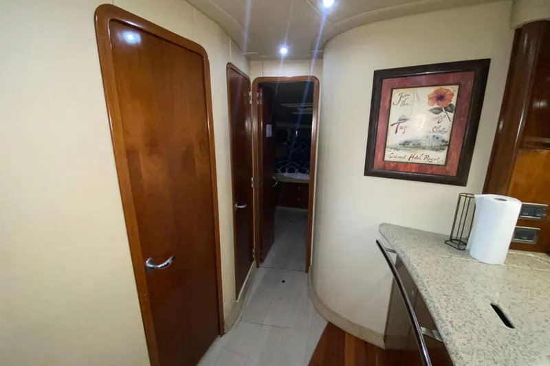 Slide: The Image of Interior hallway of 2005 Sea Ray 500 Sundancer yacht with wooden doors and framed artwork. - 32