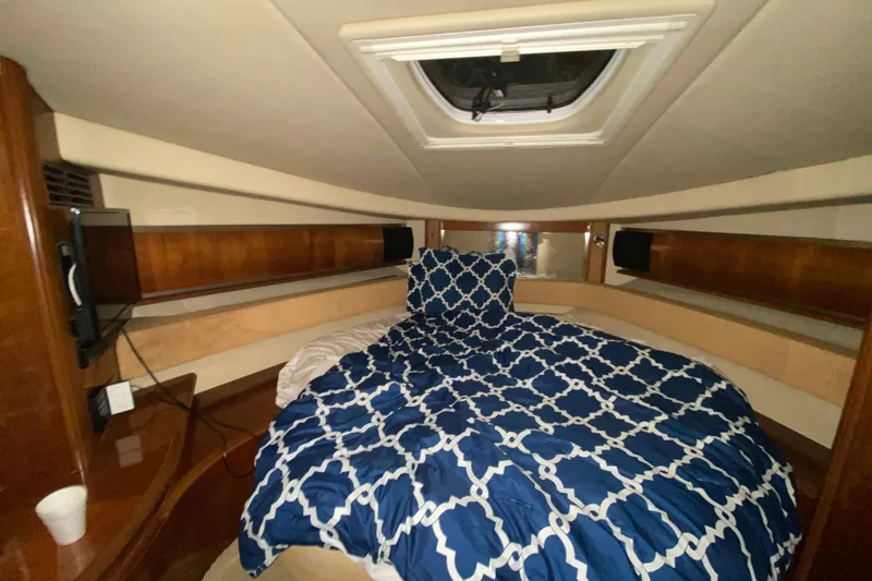 Slide: The Image of Luxurious cabin interior of 2005 Sea Ray 500 Sundancer yacht with patterned bedding. - 39