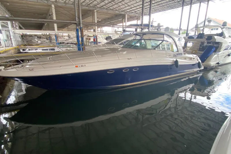 Slide: The Image of 2005 Sea Ray 500 Sundancer yacht docked in a marina under a covered structure. - 4